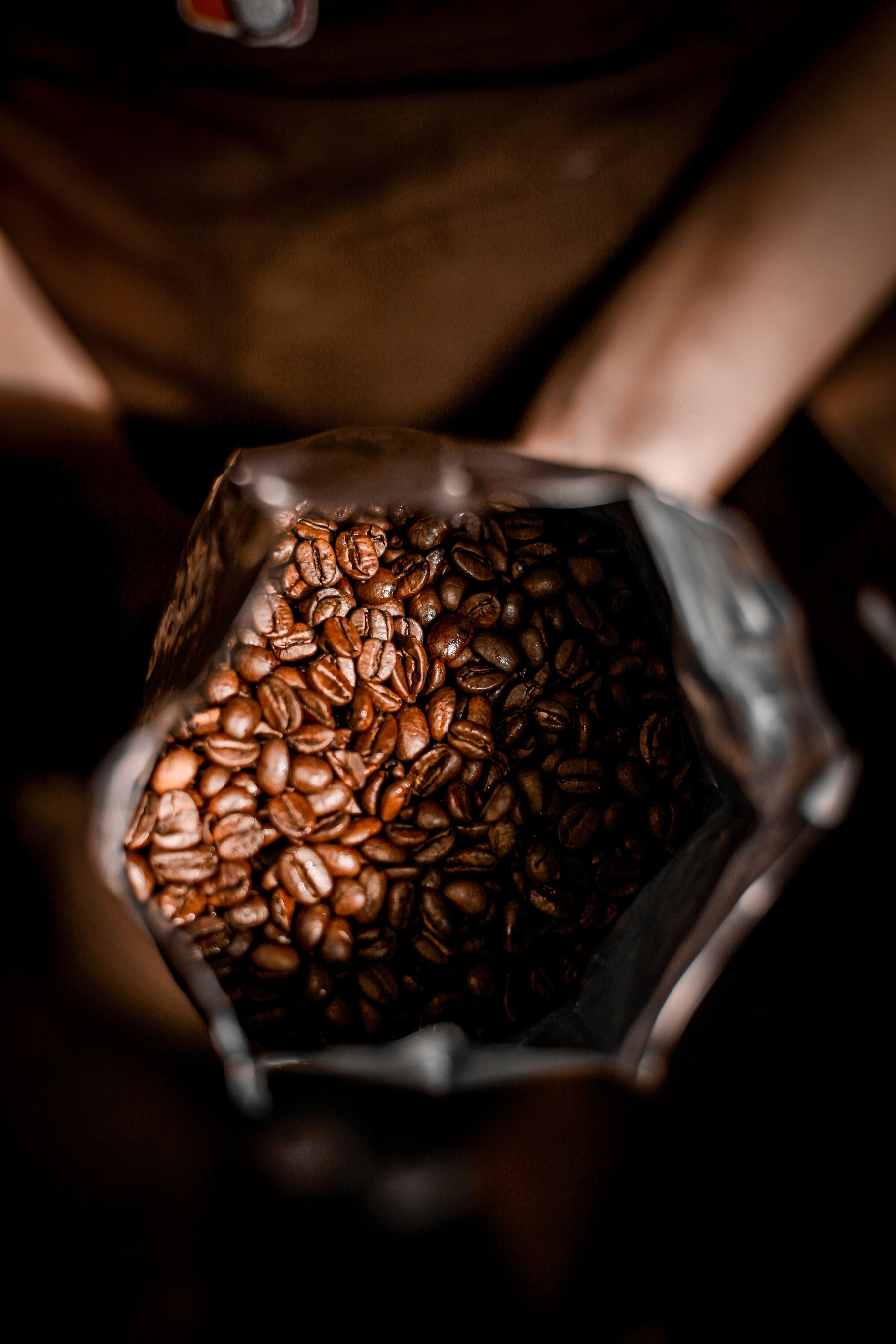 Mains tenant un sac ouvert de grains de café