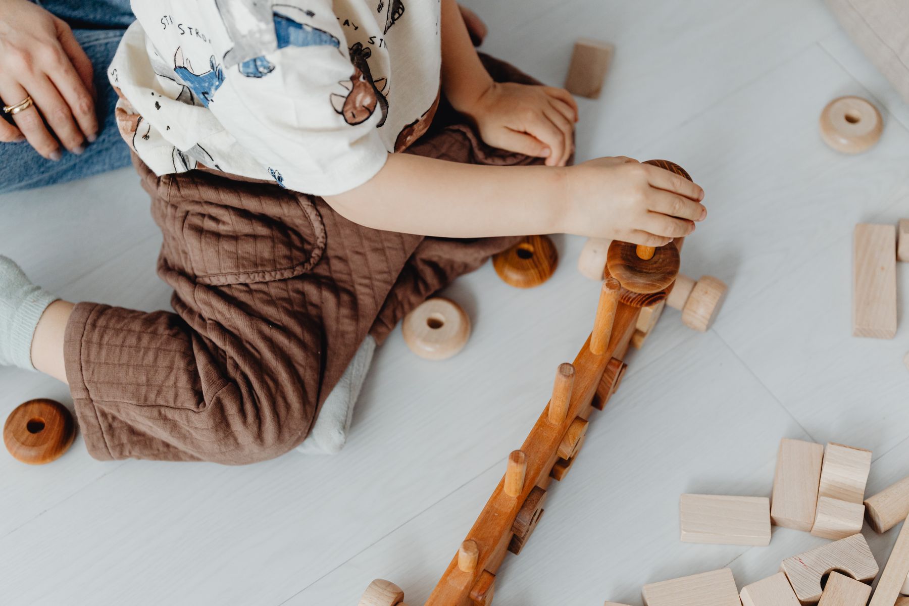 Un enfant jouant avec des blocs de bois et un train jouet